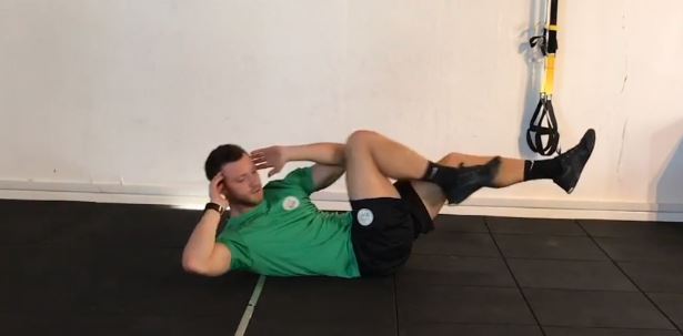 Lying knee to elbow with opposite knee and elbow